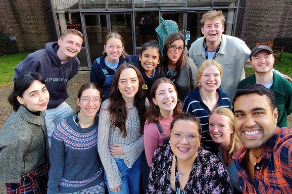 A selfie of the current YAB cohort standing outside. They all smile and look at the camera.