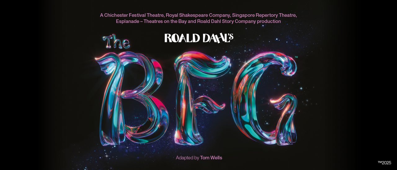 Against a black background, text reads 'Roald Dahl's The BFG'. 'Roald Dahl' is in white, with 'The BFG' in a magical, shimmering type with pink, purple, orange and teal glowing and blending throughout. The texture of the text is like a tree trunk or branch.