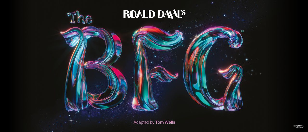 Against a black background, text reads 'Roald Dahl's The BFG'. 'Roald Dahl' is in white, with 'The BFG' in a magical, shimmering type with pink, purple, orange and teal glowing and blending throughout. The texture of the text is like a tree trunk or branch.