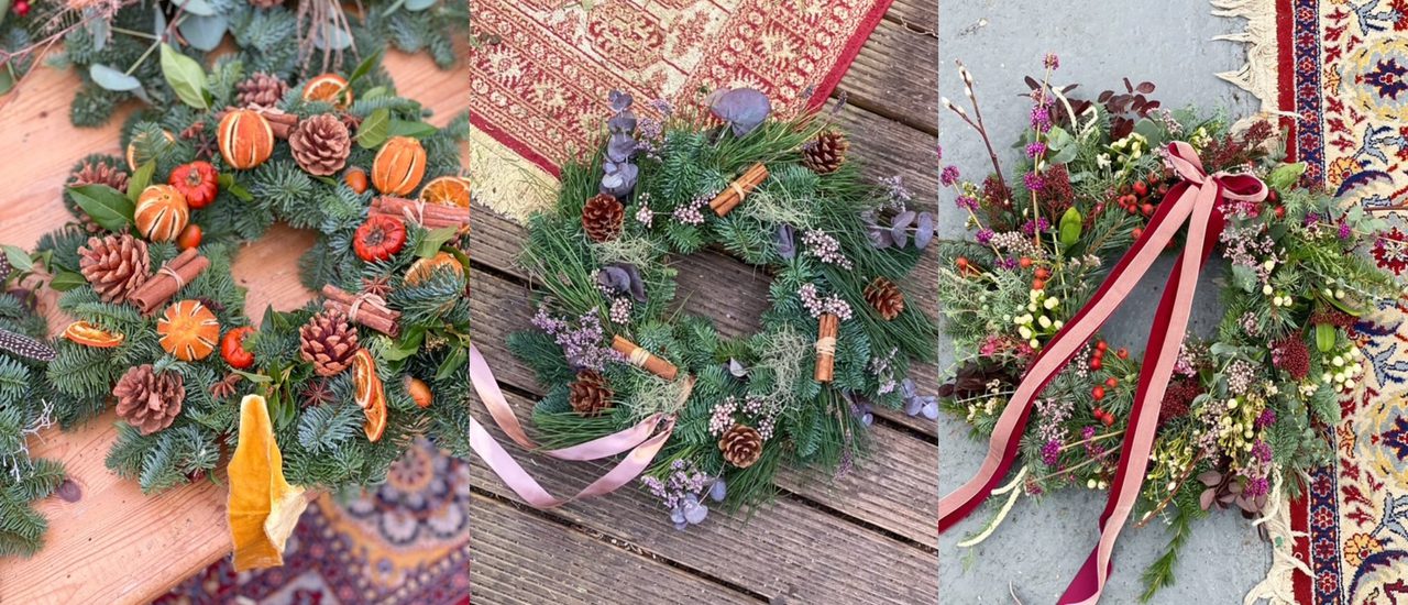 Three beautiful festive wreaths in a row. They are each decorated in a unique way, with ribbons, dried fruits and flowers.