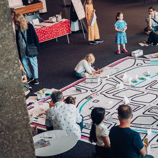 A giant map is being drawn on and added to in the Theatre foyer