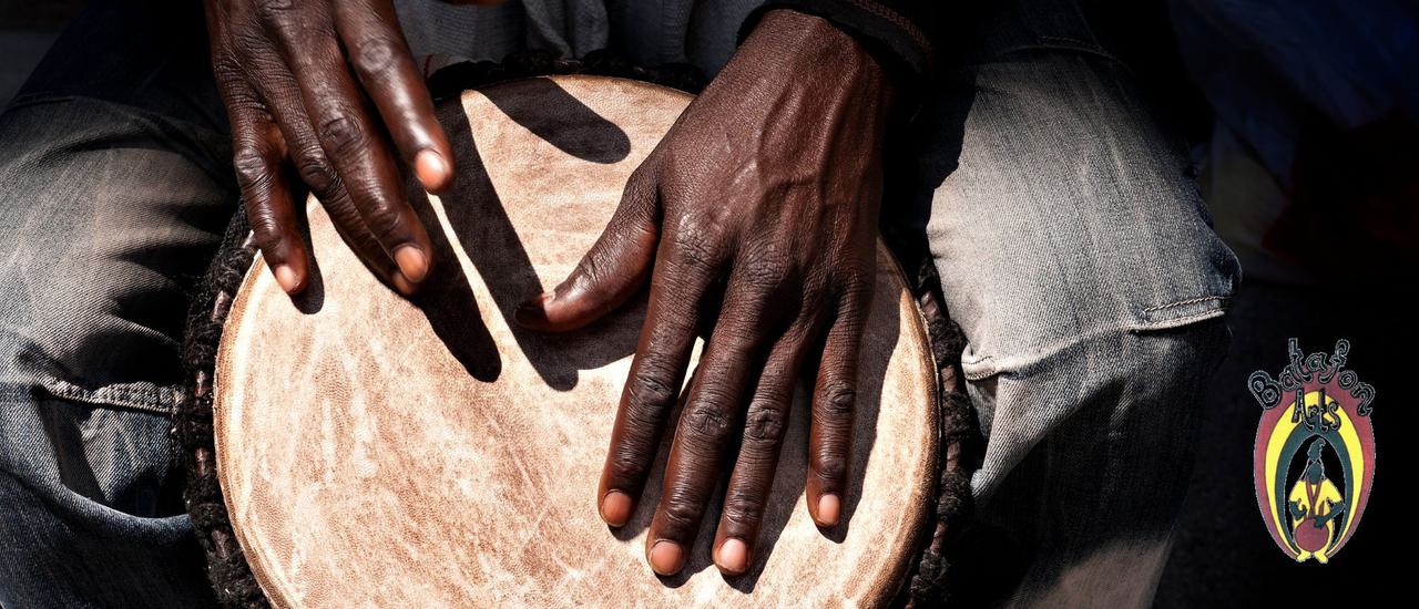 Close up photo of a man's hands drumming.