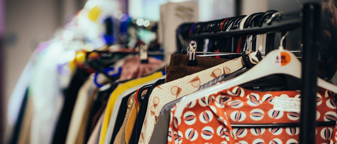 A clothing rail filled with colourful costumes backstage at CFT.