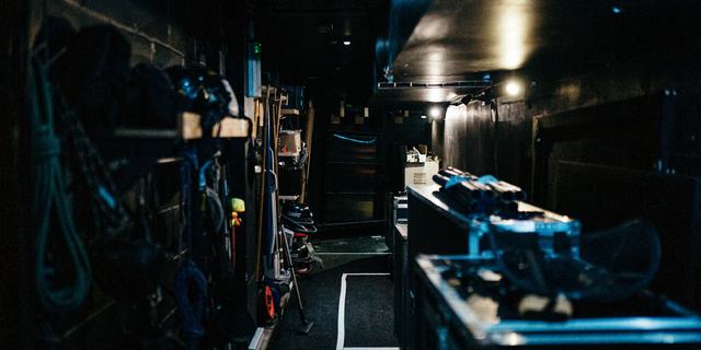A backstage corridor in the Minerva, with boxes and ropes stored on and against the walls
