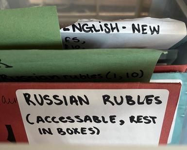 A close up of the label on a folder that reads 'Russian Rubles' (accessible, rest in boxes).