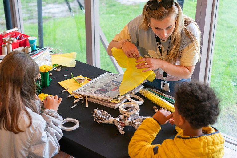 Two young children take part in a craft workshop.