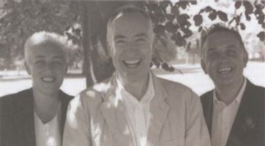 Black and white photograph of Ruth Mackenzie, Martin Duncan and Steven Pimlott. They all look at the camera, smiling.