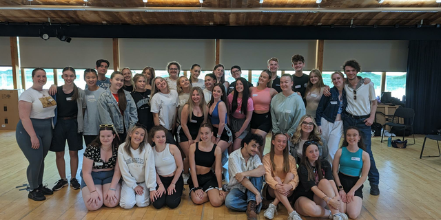 A groups of Chichester College students posing for the camera in the Rehearsal Room.