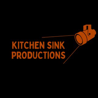 A black background with 'Kitchen Sink Productions' written in bold orange lettering. A graphic of a spotlight in the same orange frames the words.