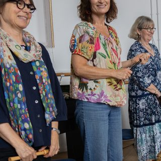 Three performers in a rehearsal room.