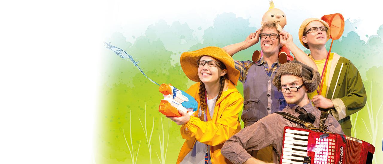 Four brightly dressed people, all wearing glasses, holding an array of objects: to the left, a smiley woman in a yellow raincoat and rain hat holds an orange and blue water gun. To her right is a man in a brown shirt and brown deerhunter hat with a quizzical explression on his face, holding a red accordian. Behind him a man in a dark grey shirt has a puppet on his shoulders. Back right in the image a man in a green raincoat and yellow tshirt and hat holds an orange fishing net. There's a backdrop of green and blue and light blue in a dappled effect.