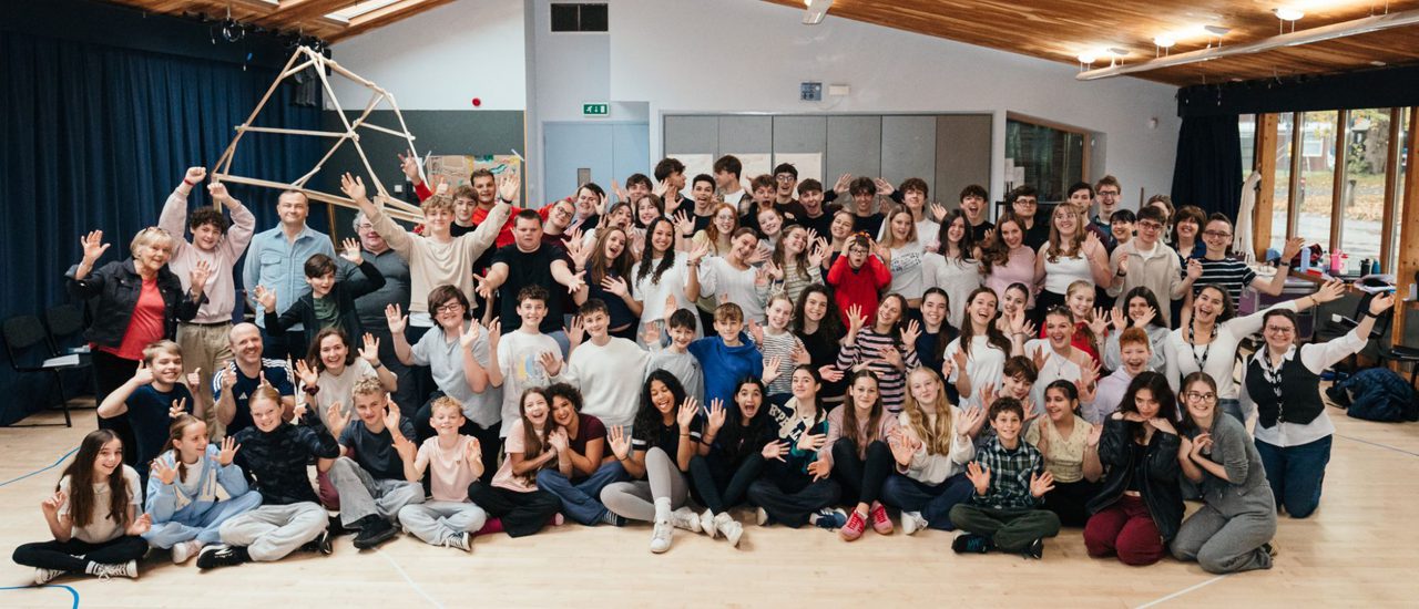 The cast of A Boy Called Christmas in rehearsals: they are smiling and making silly faces to the camera