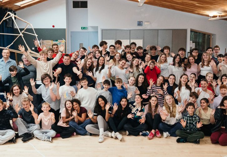 The cast of A Boy Called Christmas in rehearsals: they are smiling and making silly faces to the camera