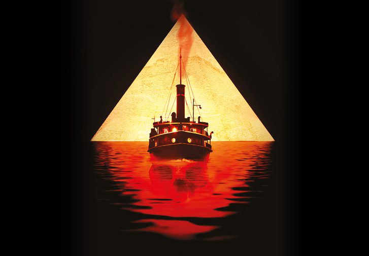 White and gold text on a black background reads 'Agatha Christie's Death on the Nile, adapted for the stage by Ken Ludwig, directed by Lucy Bailey.' In the centre is a graphic depicting a golden triangle with the silhouette of a ship, sailing on red water with the faint outline of a skull hidden within it.