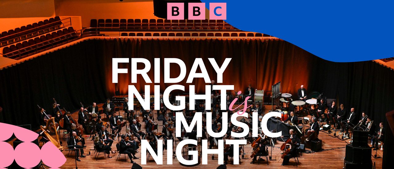 The BBC Concert Orchestra sit performing on a stage with a red curtain in the background. Text on top of the image reads: 'BBC Friday Night Is Music Night' with yellow, pink and blue graphics in the corners.