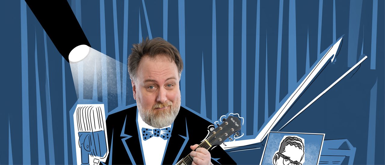 A man (Mitch Benn), who has light brown/ grey hair and a thick grey beard and moustache, smiles and plays the guitar. His body is replaced with a cartoon suit and bow tie. The background is also a cartoon illustration with a spotlight, microphone and record cover, all in blue, black and white.