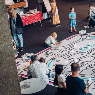 A giant map is being drawn on and added to in the Theatre foyer