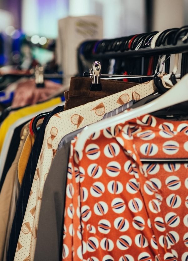 A clothing rail filled with colourful costumes backstage at CFT.