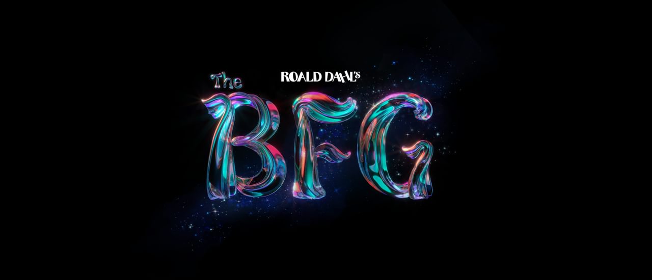 Against a black background, text reads 'Roald Dahl's The BFG'. 'Roald Dahl' is in white, with 'The BFG' in a magical, shimmering type with pink, purple, orange and teal glowing and blending within it. The texture of the text is like a tree trunk or branch.