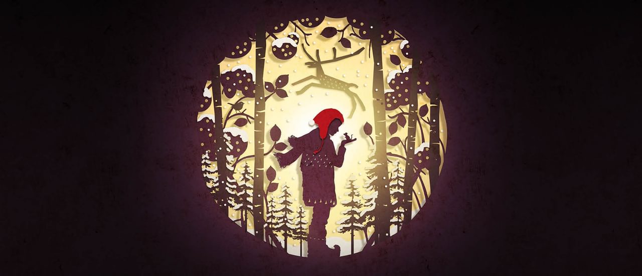 A circular cut-out silhouette, like an old-fashioned fairy story image, shows a boy wearing a red cap, a scarf, coat and boots, holding up his hand on which is perched a mouse. He stands surrounded by snow-laden pine trees, and a reindeer is leaping above his head.