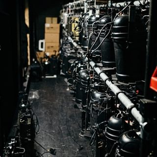 Two racks of stage lights in storage