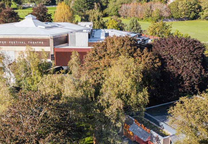An aerial shot of Chichester Festival Theatre and The Nest, surrounded by trees and parkland.
