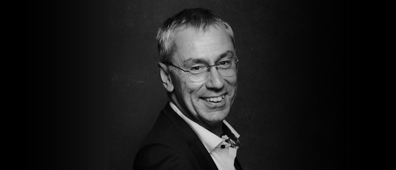 A black and white portrait of Alan Finch
