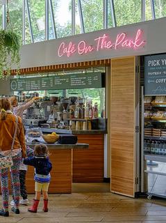 A family are queuing at the Cafe on the Park