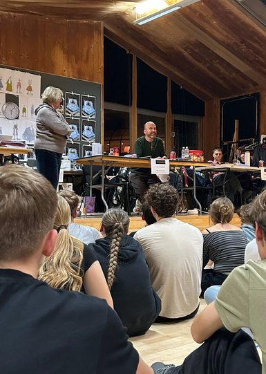 The Youth Theatre cast speaking with author Matt Haig in a busy rehearsal room.