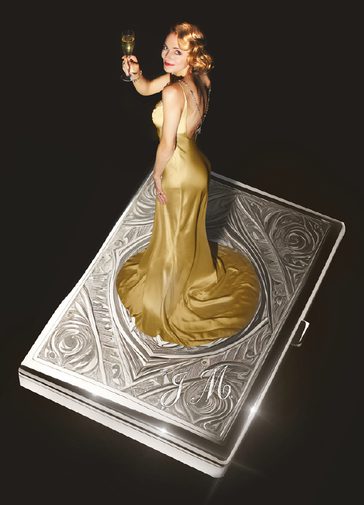 A giant, decorative, silver cigarette case floats against a black background. A young woman stands on top wearing a glamorous golden silk gown, holding a glass of champagne and looking to the camera with a smile. Her golden hair is curled and she wears red lipstick.